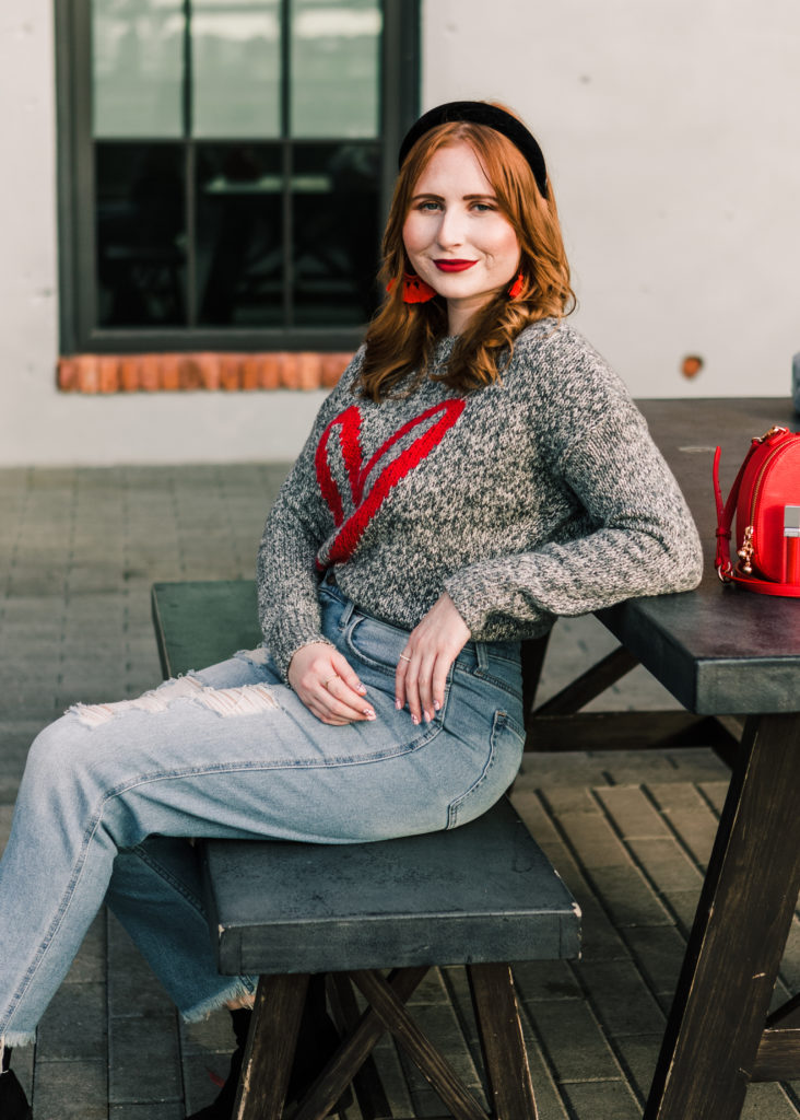 10 Valentine's Day Sweaters to wear. Tampa blogger Affordable by Amanda wears a Heart Sweater from LOFT and high-rise distressed mom jeans from Hollister. 10 Casual Valentine's Day Sweaters to style this year. 