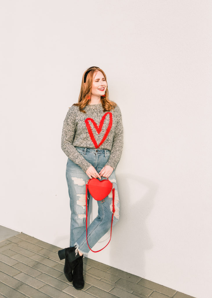 10 Valentine's Day Sweaters. Affordable, casual V-day sweaters. Tampa blogger Affordable by Amanda wears a Heart Sweater from LOFT and high-rise distressed mom jeans from Hollister. 10 Casual Valentine's Day Sweaters to style this year. 