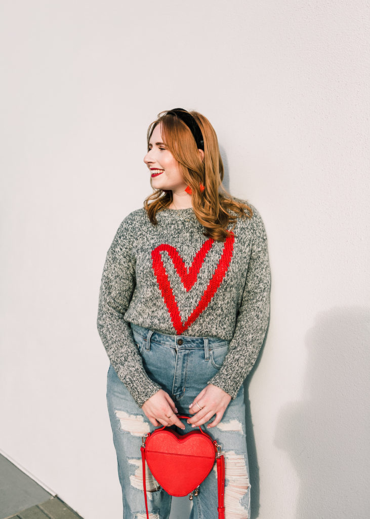 10 Valentine's Day Sweaters. Tampa blogger Affordable by Amanda wears a Heart Sweater from LOFT and high-rise distressed mom jeans from Hollister. 10 Casual Valentine's Day Sweaters to style this year. 