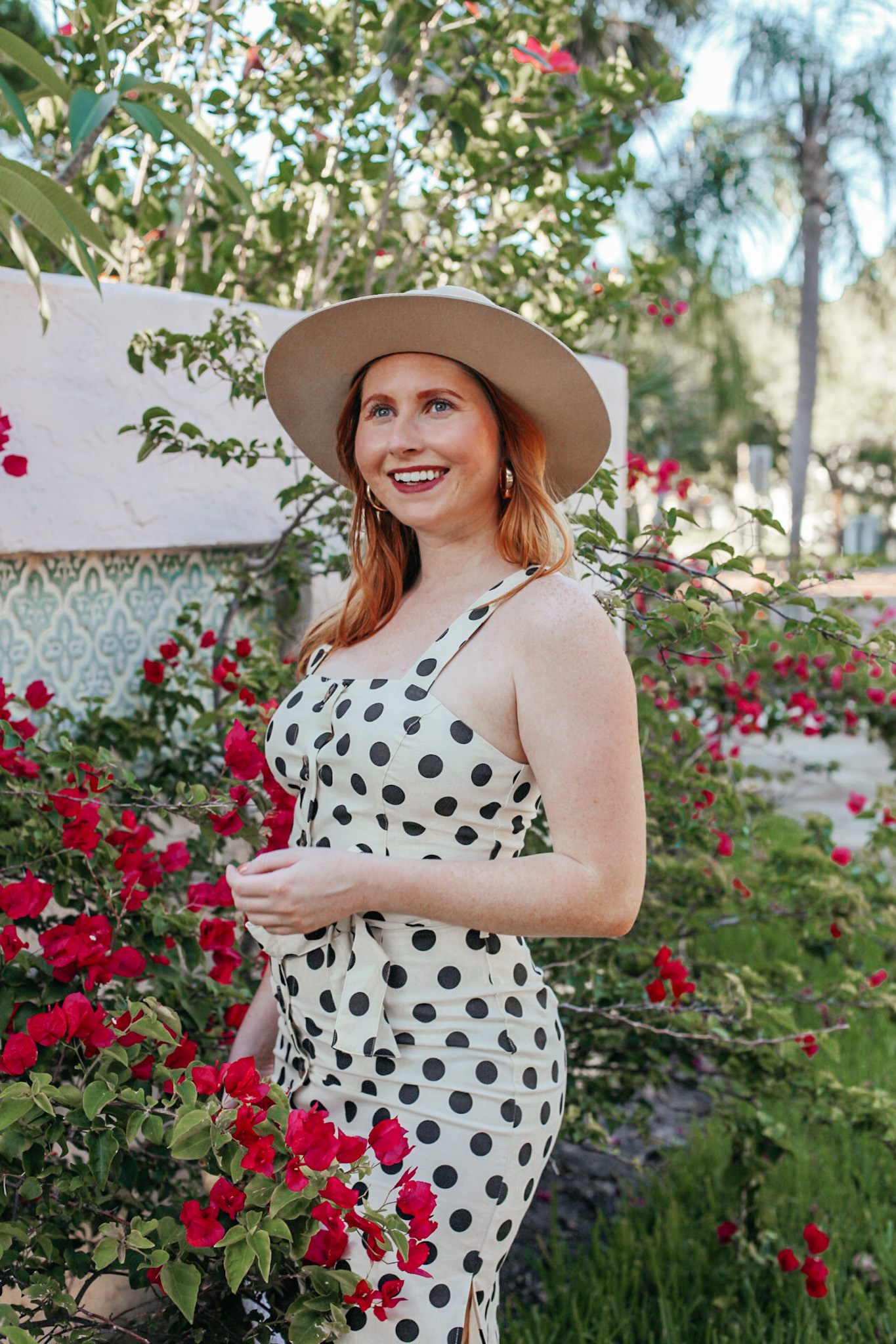 A Budget-Friendly Everyday Dress. Florida style blogger Amanda Burrows of the fashion blog Affordable by Amanda shares her favorite Spring Dresses Under $50. Amanda wears a casual JustFab Belted Button Front Dress with polka dot print. 