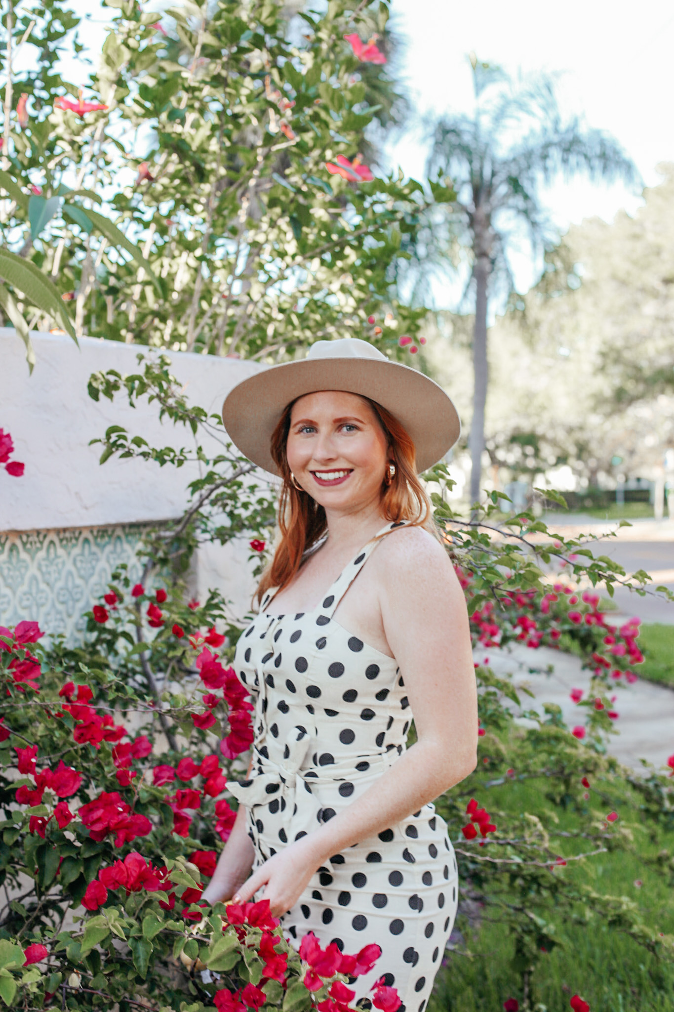 A Budget-Friendly Everyday Dress. Florida style blogger Amanda Burrows of the fashion blog Affordable by Amanda shares her favorite Spring Dresses Under $50. Amanda wears a casual JustFab Belted Button Front Dress with polka dot print. She is in St. Petersburg, Florida. 