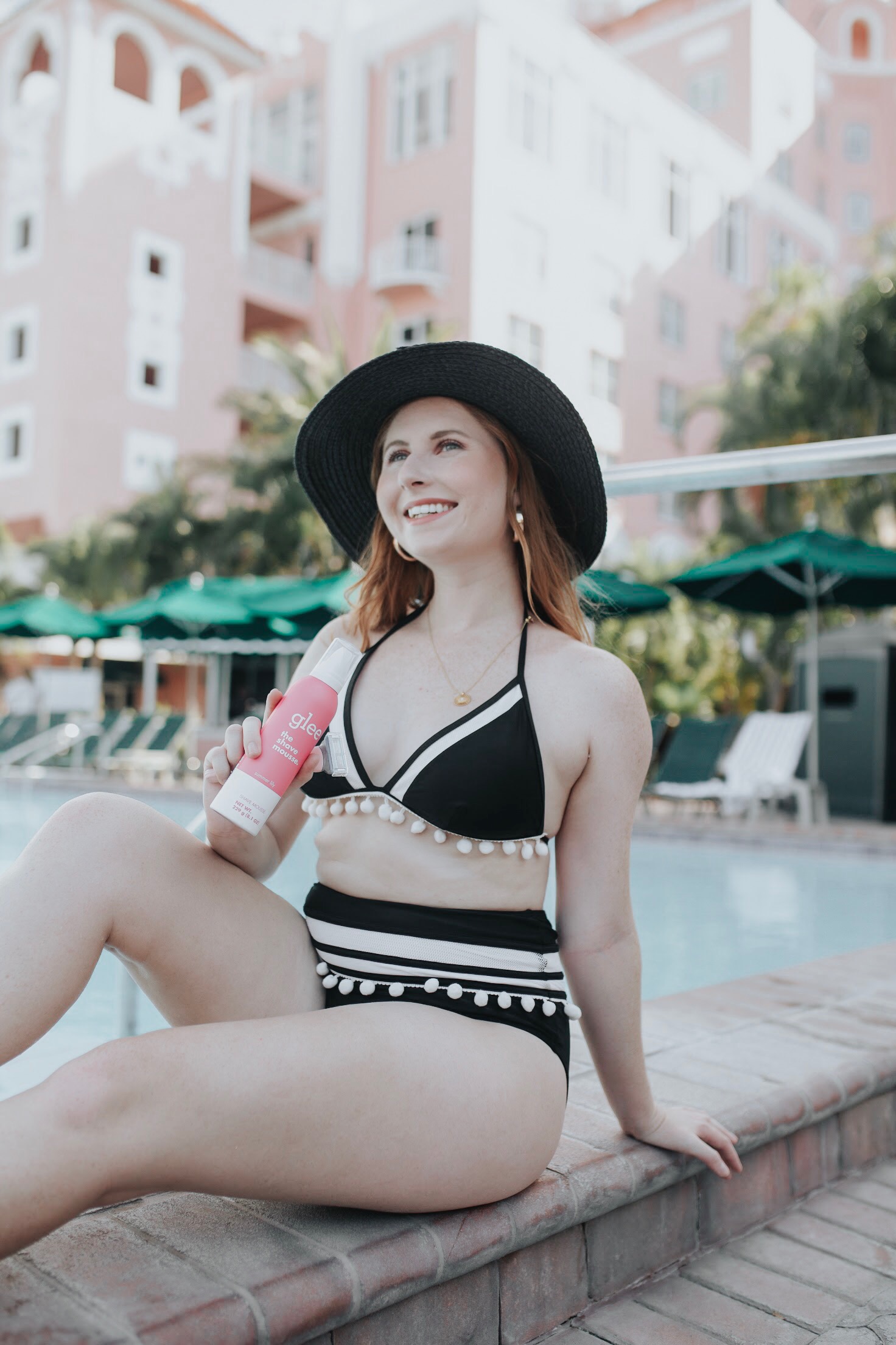 Amanda Burrows sits by the pool at the Don CeSar Hotel wearing a black and white 2-piece bikini. She is holding up a can of glee Summer Lily Shave Mousse. Florida style blogger Amanda Burrows shares her step by step guide to shaving your legs. How to shave your legs in the shower quickly. How to Shave Your Legs Perfectly | Billie Razor Starter Kit THE HANDLE, MAGIC HOLDER & 2 BLADES