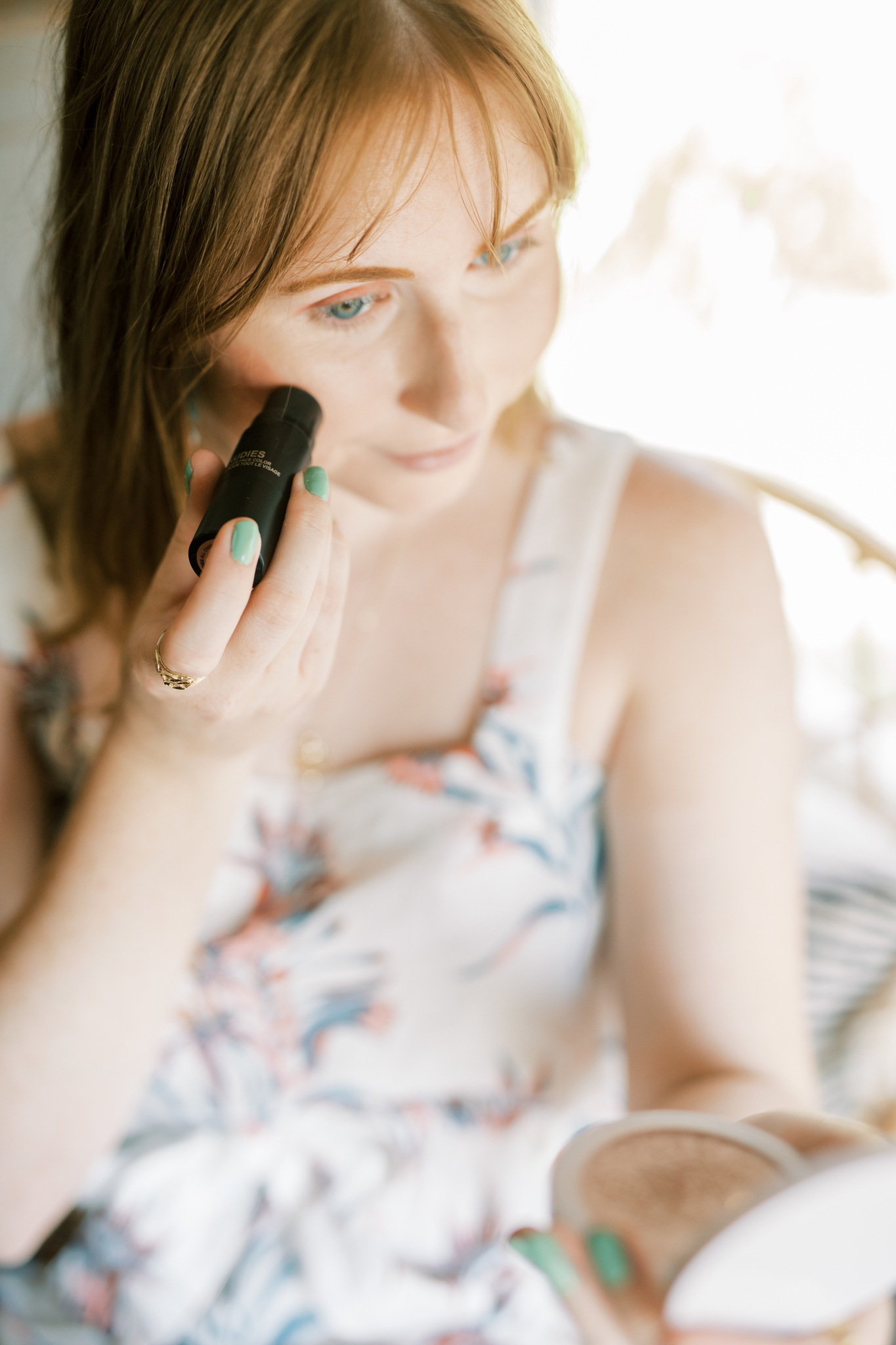 Affordable by Amanda shares her summer makeup tutorial | she is holding a NUDESTIX nudies matte blush & bronze product and applying the shade Bare Back to her cheeks. 