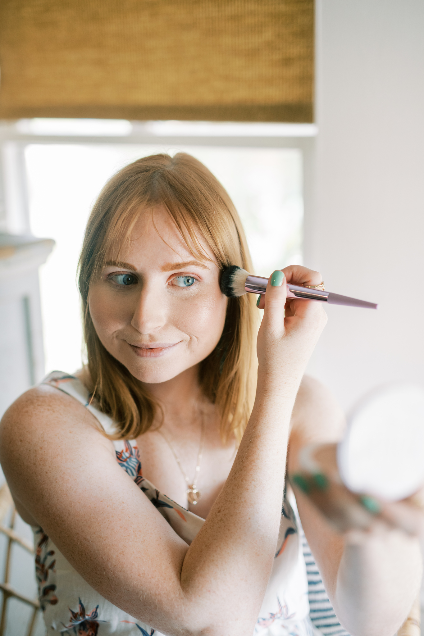 Amanda Burrows, of Affordable by Amanda, applies Milk Makeup Flex Highlighter to the top of her cheekbone for a glistening highlight. She uses the Lit shade of Milk Makeup on her cheeks for added highlight and shine for the summertime. 