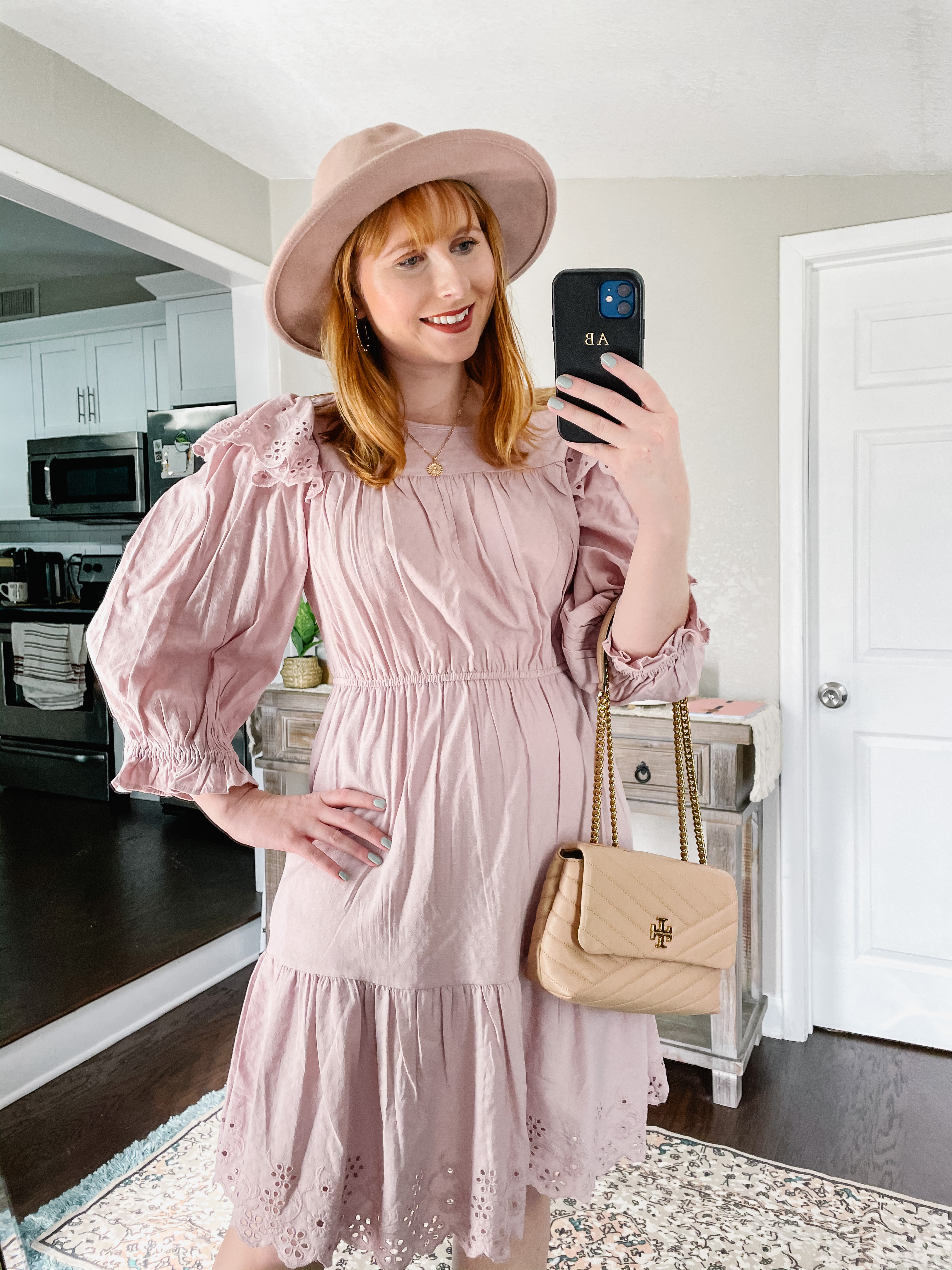 Women's Puff Long Sleeve Ruffle Dress - Universal Thread™| Red-haired woman wears purple dress holding a black phone in her hand. 