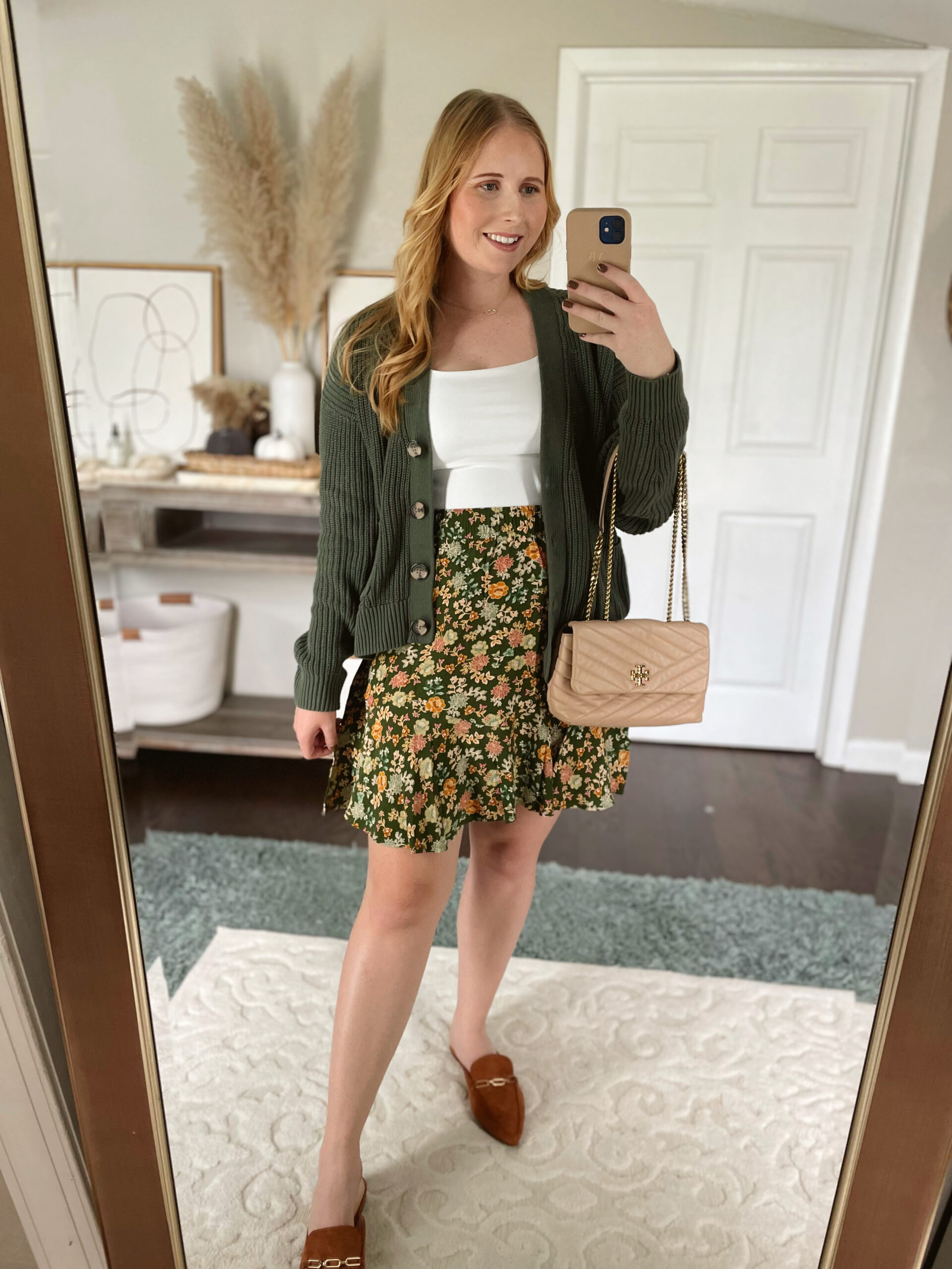 green cardigan, white top, floral flippy skirt, brown loafers