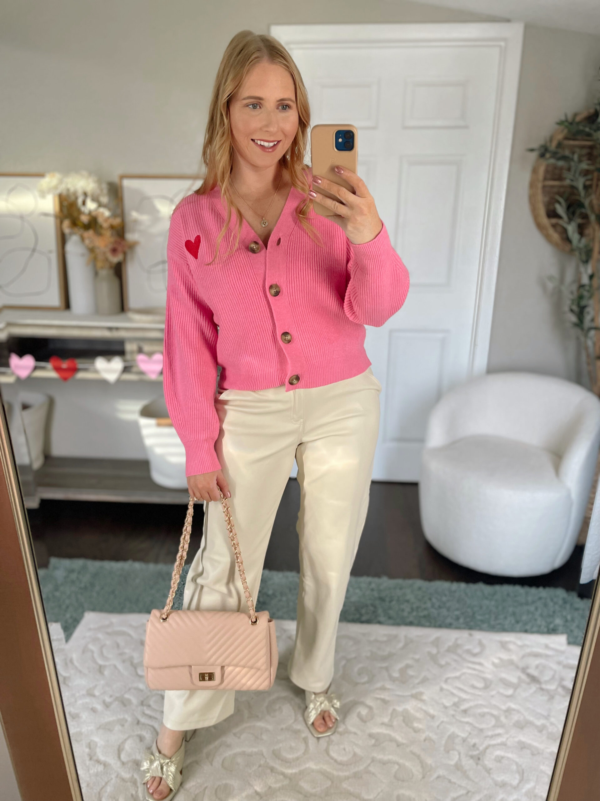 Pink heart cardigan, faux leather pants, gold heels, pink shoulder bag