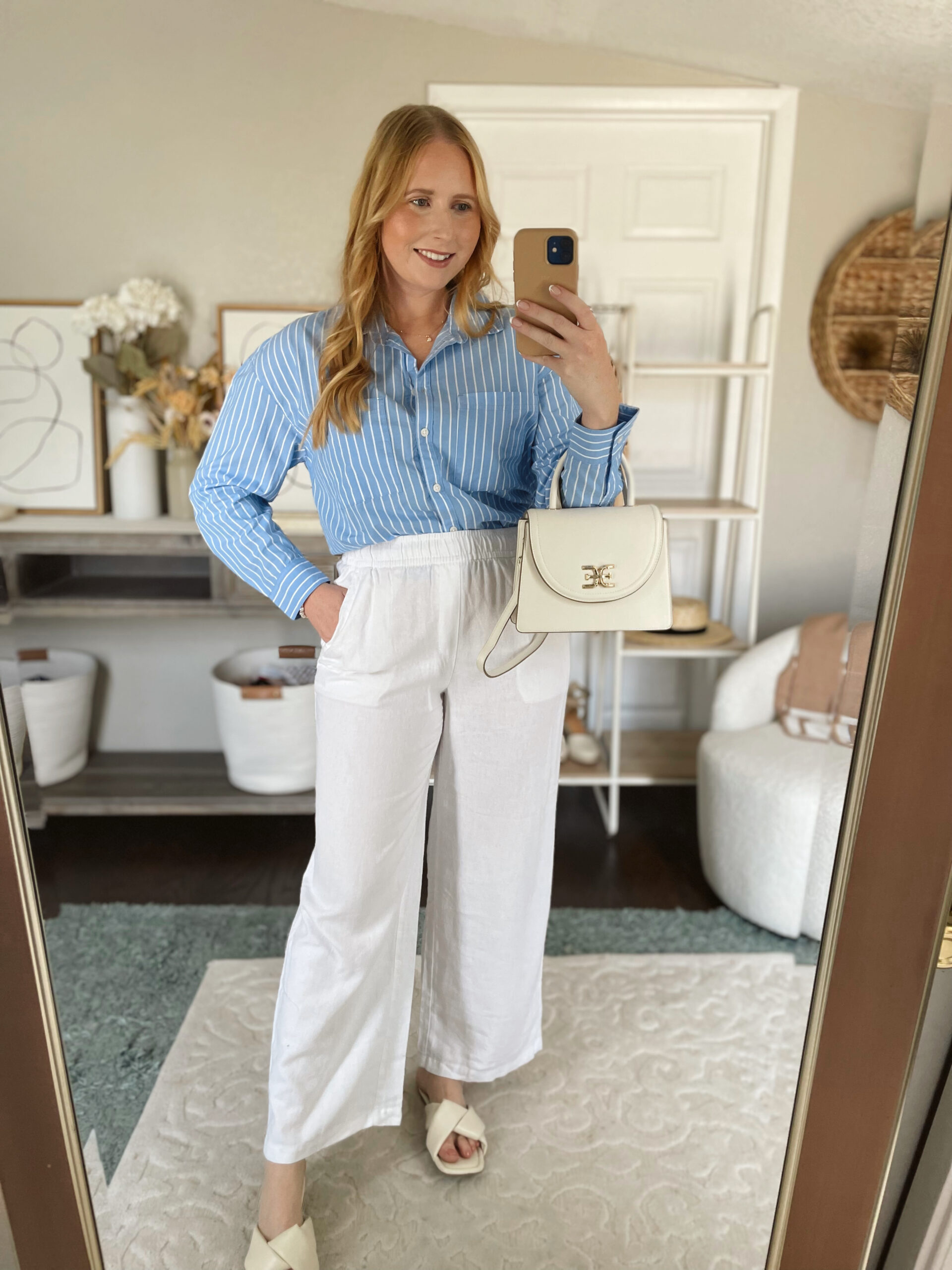 Affordable by Amanda wears a blue striped button down boyfriend shirt with white linen pants and a white satchel bag