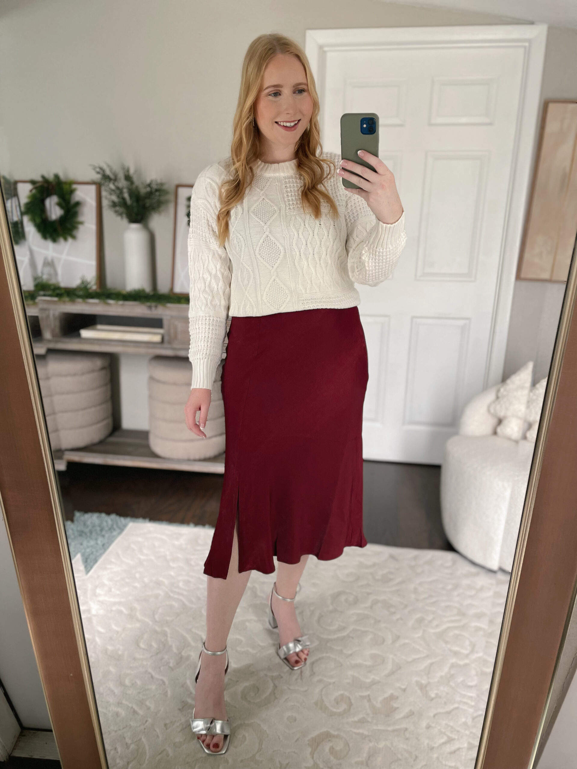 Cable knit sweater with a red midi skirt
