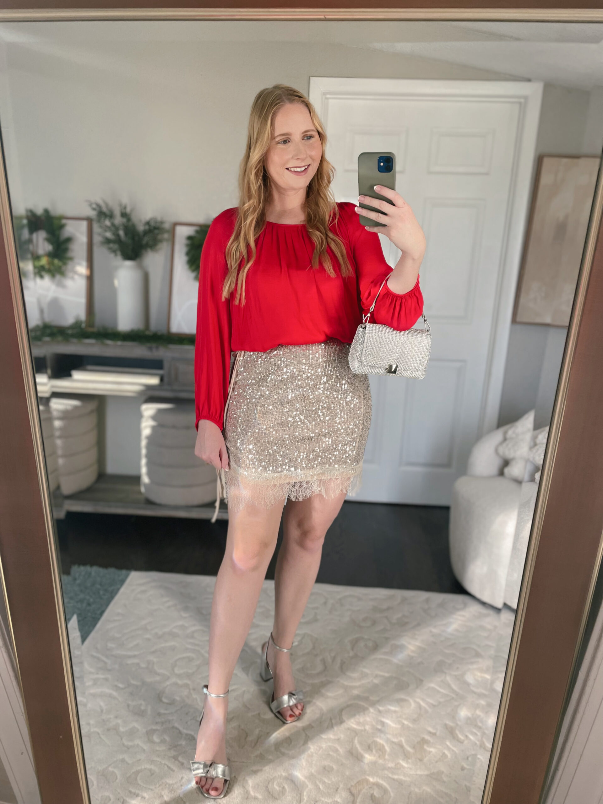 Red blouse with a silver sequin mini skirt holiday outfit idea