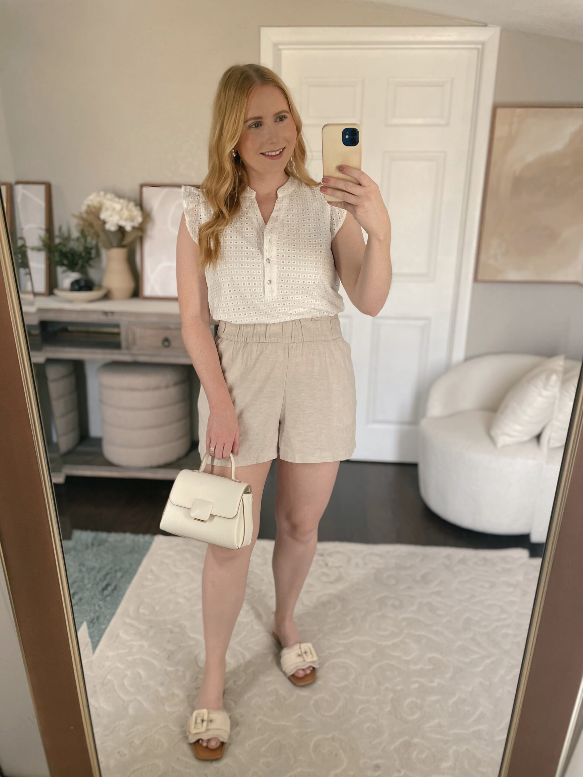 White eyelet blouse with tan linen pull on shorts
