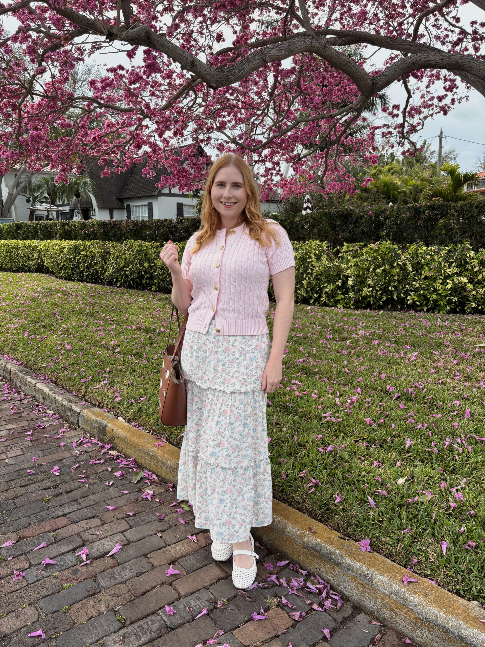 Pink cable knit cardigan worn with a floral maxi skirt outfit idea from Walmart. Mid-Size friendly walmart outfits for spring.
